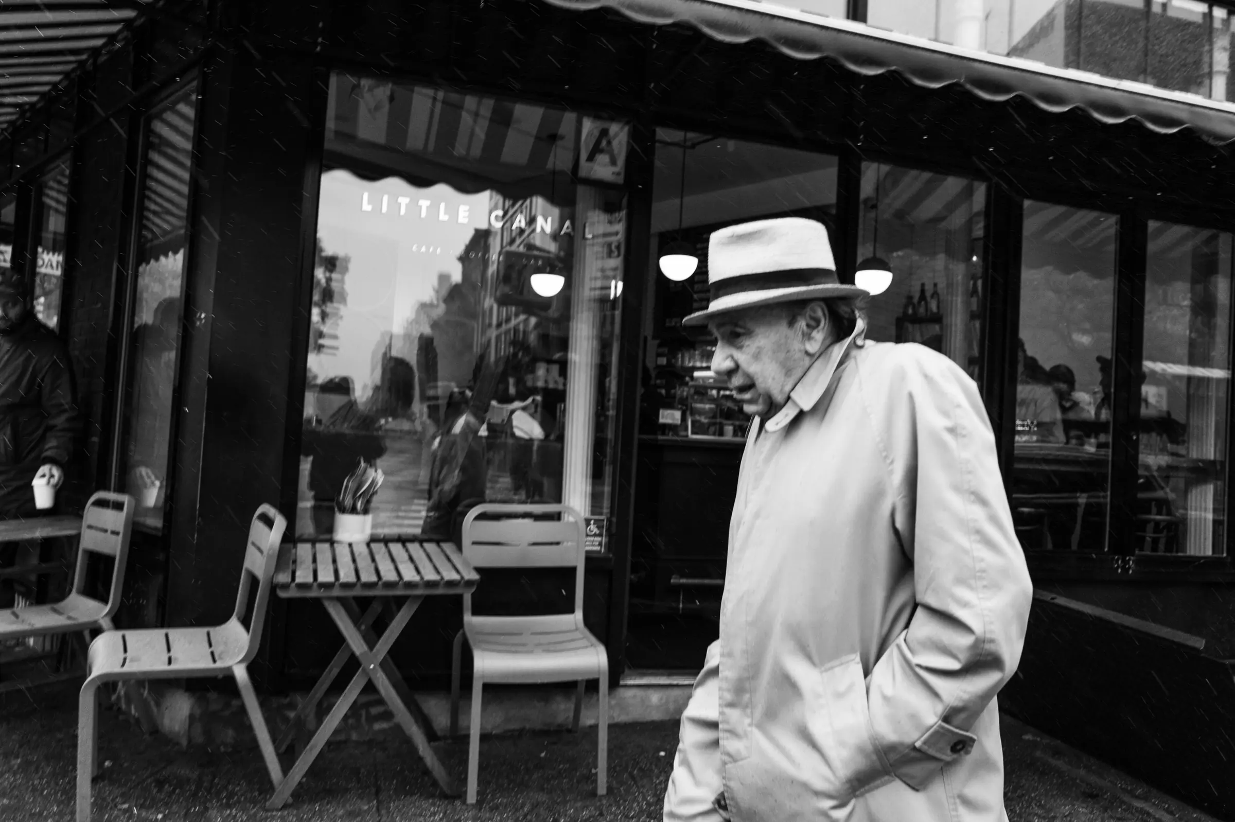 A figure outside a New York café, insider access to the city's creative community