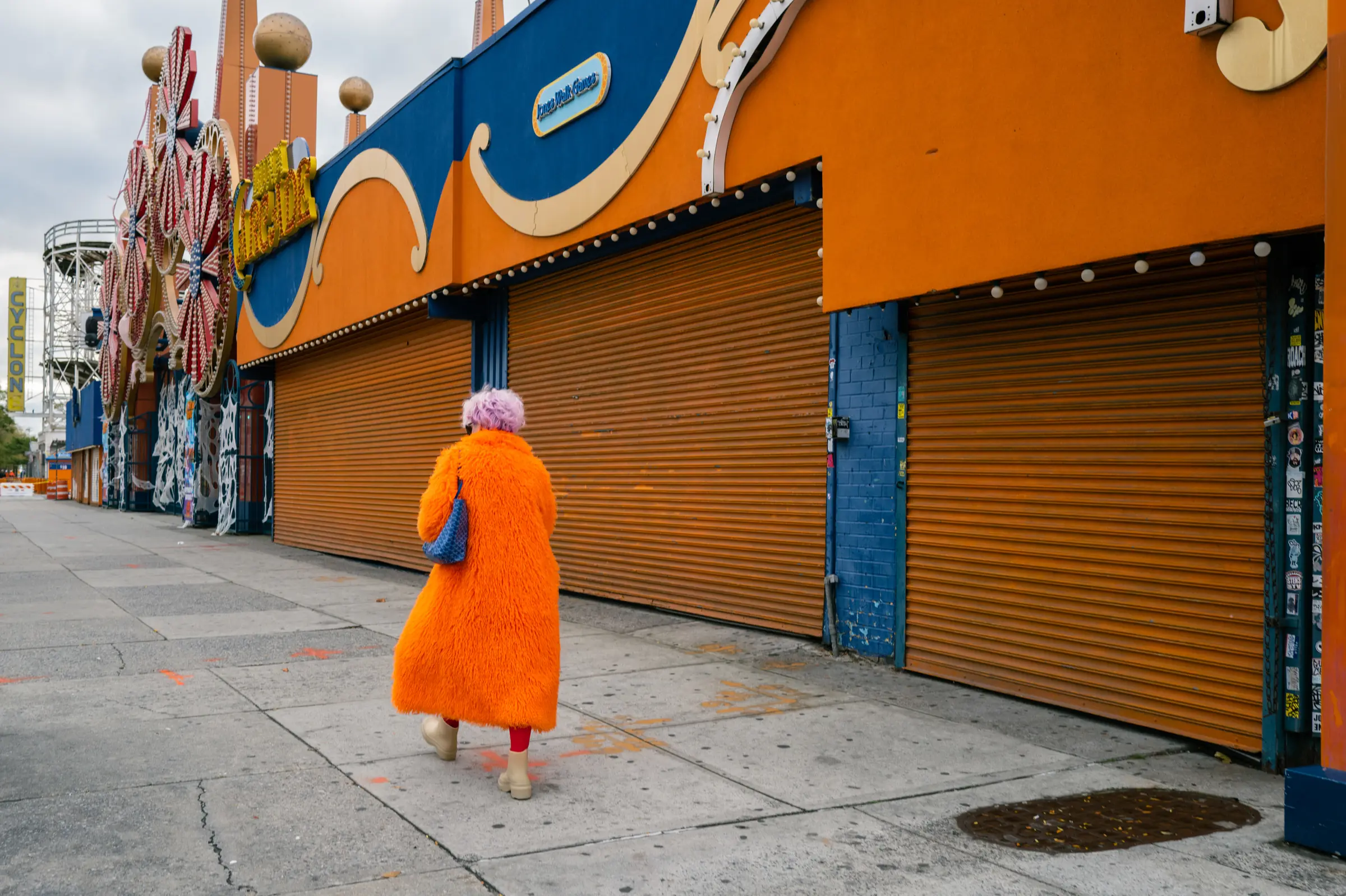 A woman in an orange coat on a New York street